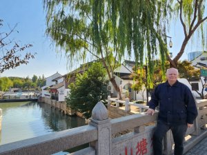 James Visser on a stone bridge across Suzhou Canal, China